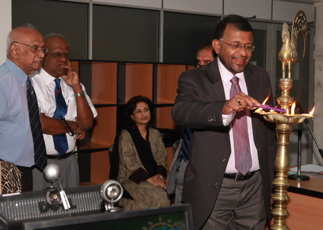 WONCA South Asia region president, Dr Preethi Wijegoonewardfene, lights the oil lamp signifying the Lamp of Learning watched by Drs Aloysius, Abeykoon and Sajeeda
