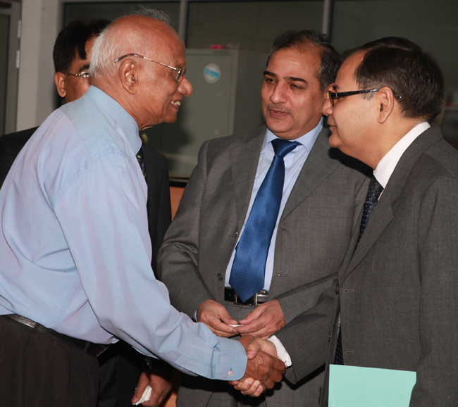 Dr Dennis Aloysius, senior most past president of College of General Practitioners of Sri Lanka, congratulates Prof Waris Qidwai watched by Dr Noor Akthar