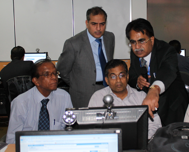 Dr Basharat Ali, Chair SAPCRN helping colleagues at the computer