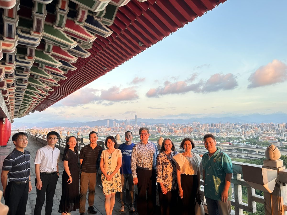 Prof. Viviana Martínez-Bianchi with TAFM colleagues on a terrace of the Grand Hotel Taipei, with the city skyline behind them