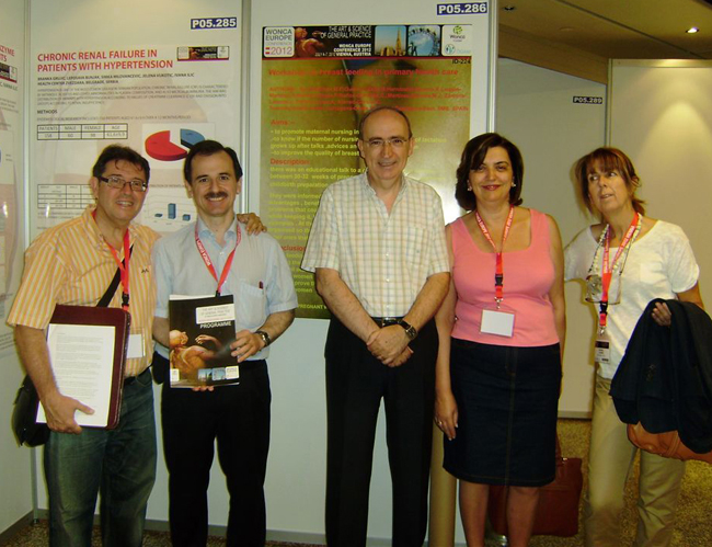Spanish group in front of poster: Workshop on breast feeding in primary health care